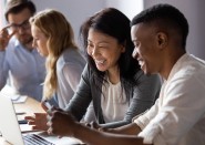 diverse group of people looking at computer