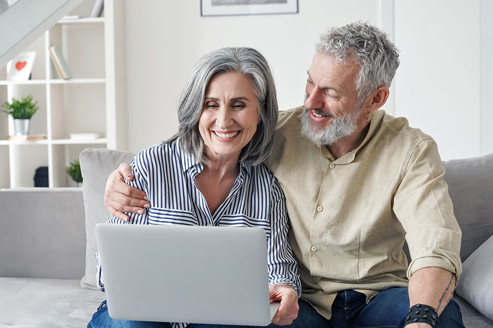 Older couple on couch looking at computer