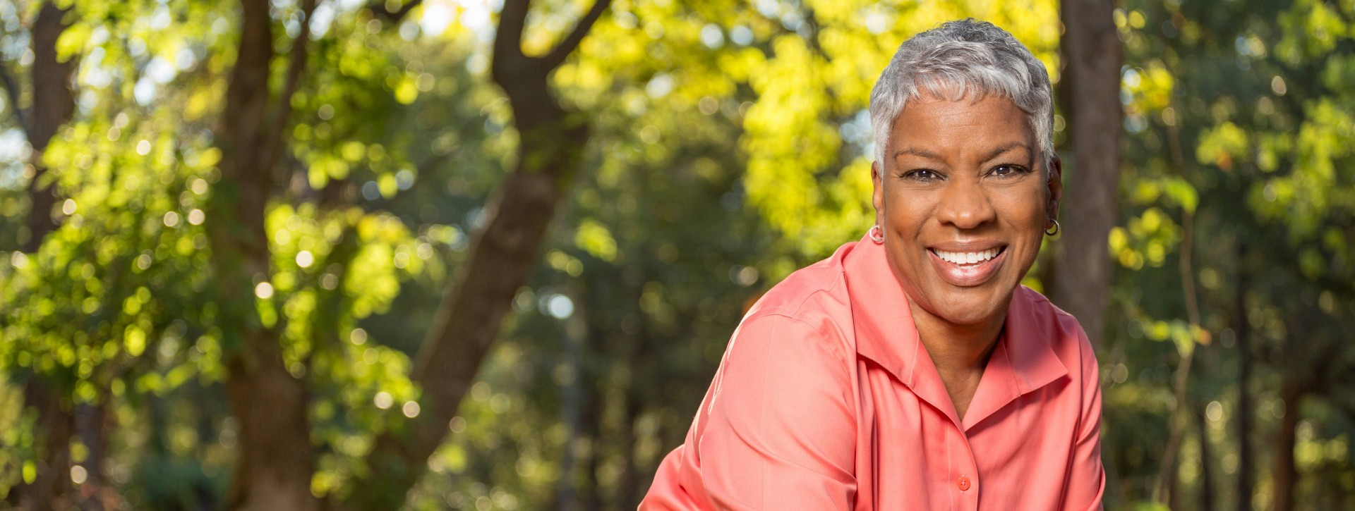 Older woman leaning on a bridge outside